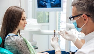 A dentist telling a patient about dental implants’ long-term benefits