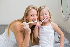 Mother and daughter brushing