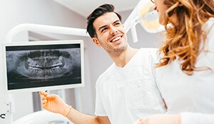 Dental assistant & patient view x-rays