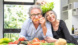 A senior couple having fun with healthy foods