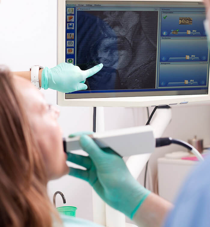 Woman viewing digital image of crown treated tooth