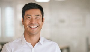 Man in white button-up shirt smiling