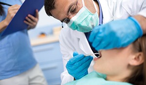 Dentist and assistant care for younger patient
