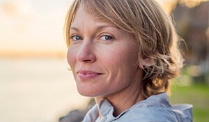 Woman smiling at sunset