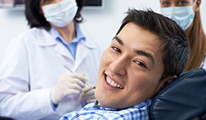 Man in 30s smiling in chair