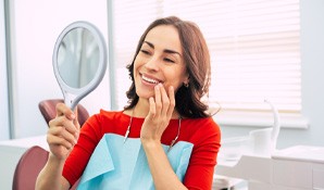 a woman smiling about her dental implants in Wichita Falls