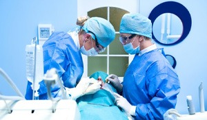 an oral surgeon performing dental implant surgery