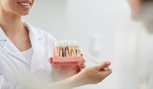 a dentist explaining the cost of dental implants