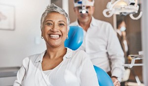 a patient smiling after paying for dental implants