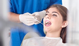 Young woman being screened for oral cancer