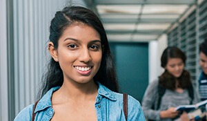Preteen girl smiling in school hallway