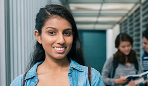 Preteen girl smiling in school hallway