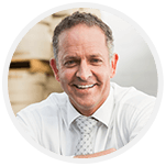 Older man smiling in shirt and tie