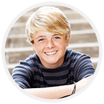 Boy with bright smile sitting on steps