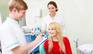 Smiling woman talking to dentist