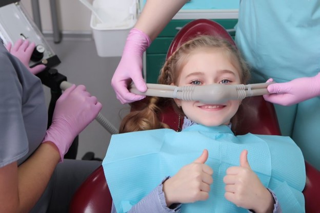 Young girl at the dentist receiving nitrous oxide sedation.